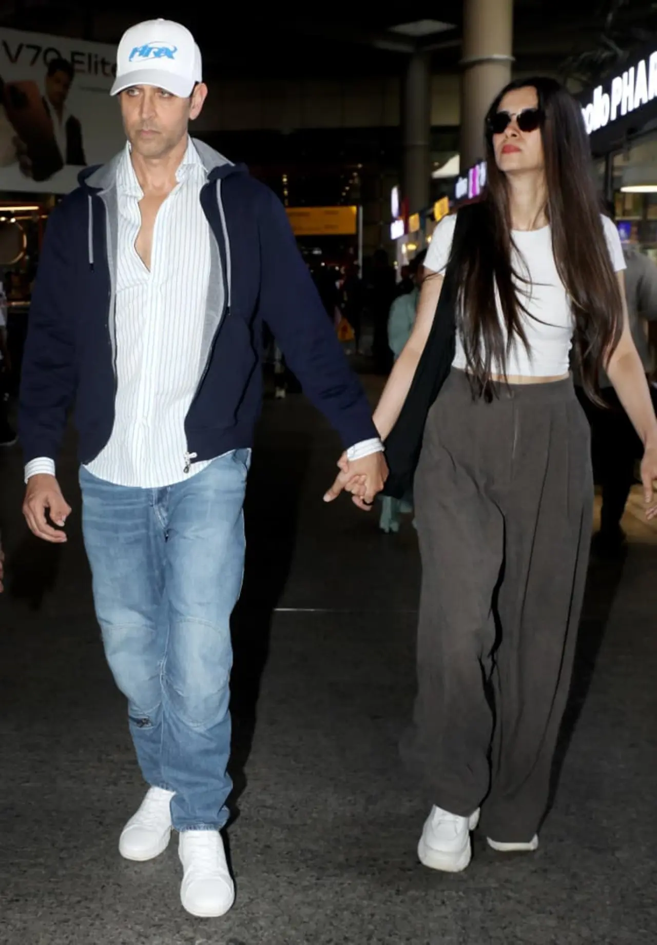 The lovebirds walked hand in hand, dressed in casuals after a flight.